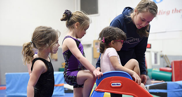 Children in the Gigueres preschool program learning using a slide.